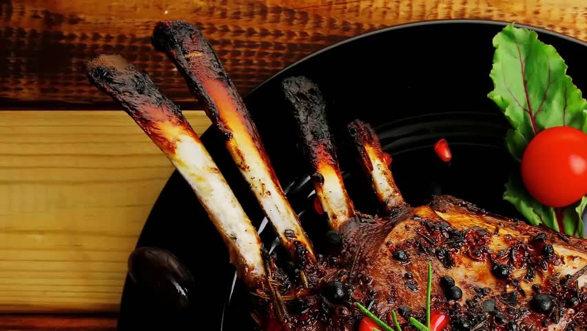 served ribs with rosemary and cherry tomato hidef slow motion intro