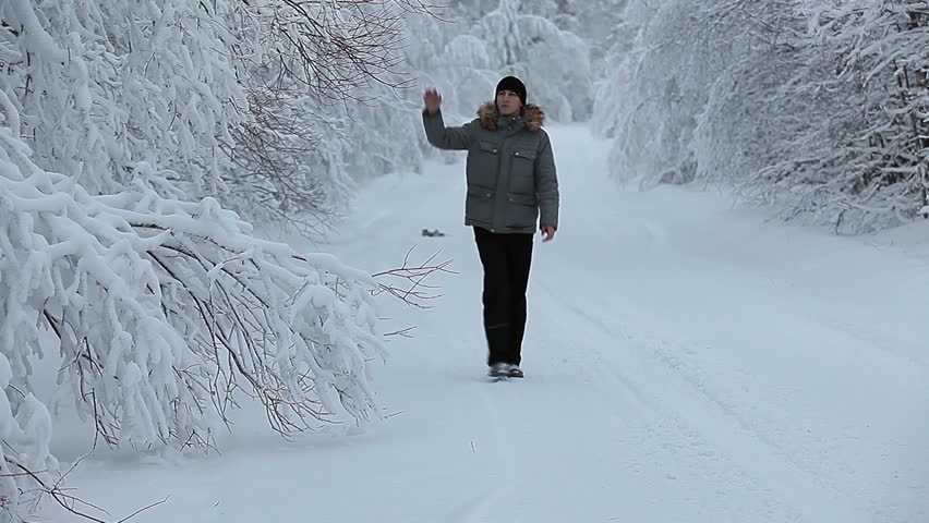 One Caucasian male going towards along winter road