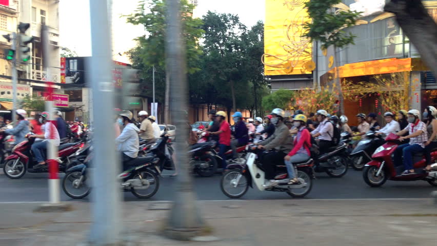 HO CHI MINH CITY - FEBRUARY 1: Panning view of scooter traffic in Ho Chi Minh City, Vietnam, in February 1, 2013