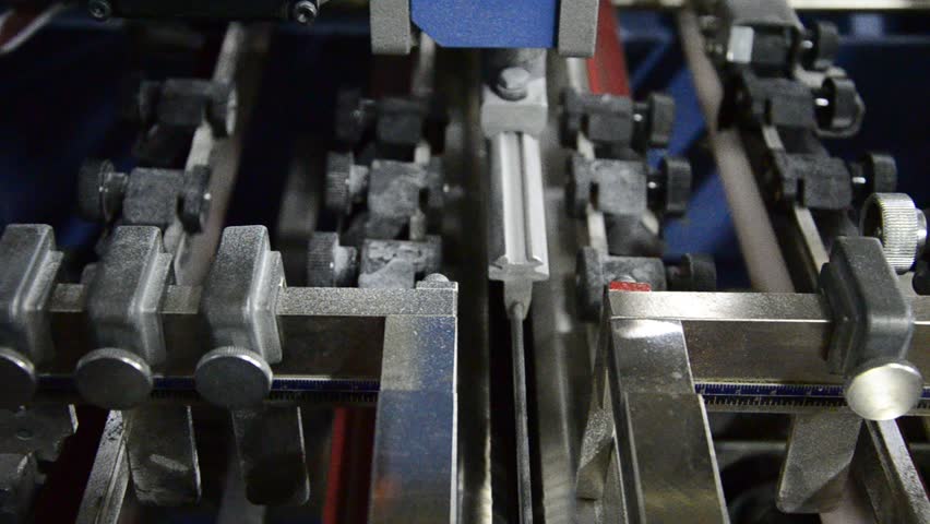 folding machine folds printed offset sheet as part of newspaper brochure in print house
