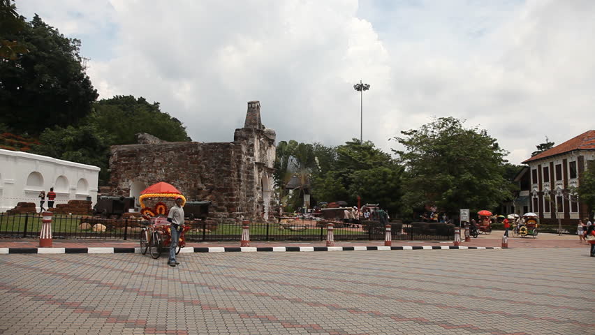 MALACCA, MALAYSIA - NOV 4: Timelapse of trishaw driving in front of A Famosa in Malacca, Malaysia on 4th November 2012