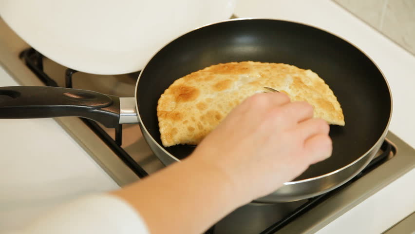Woman preparing chebureki (crimean tatar national dish) at home