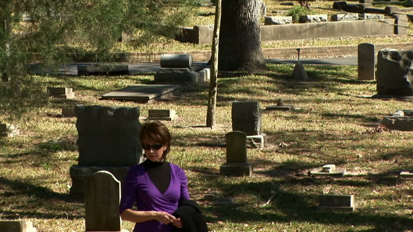 mourning woman crying at a grave