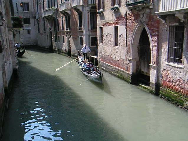 Venice: Gondola passage along an unknown canal 