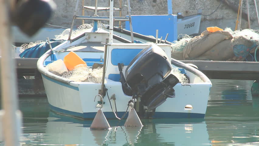 boat anchored at Jaffa port among other boats on a sunny day