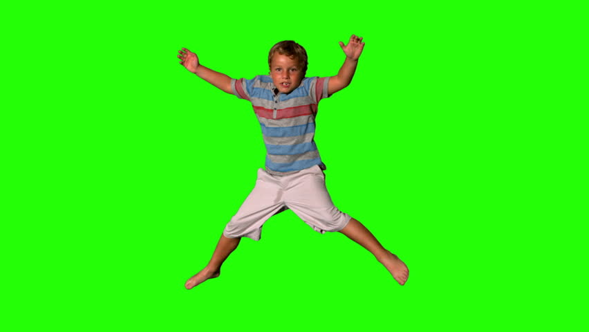 Boy jumping on a green screen in slow motion