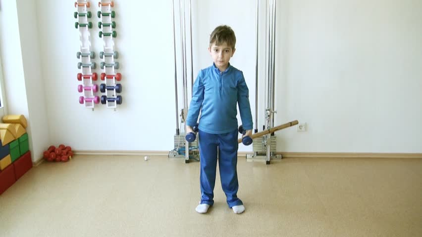 Child does therapeutic exercises in the gym