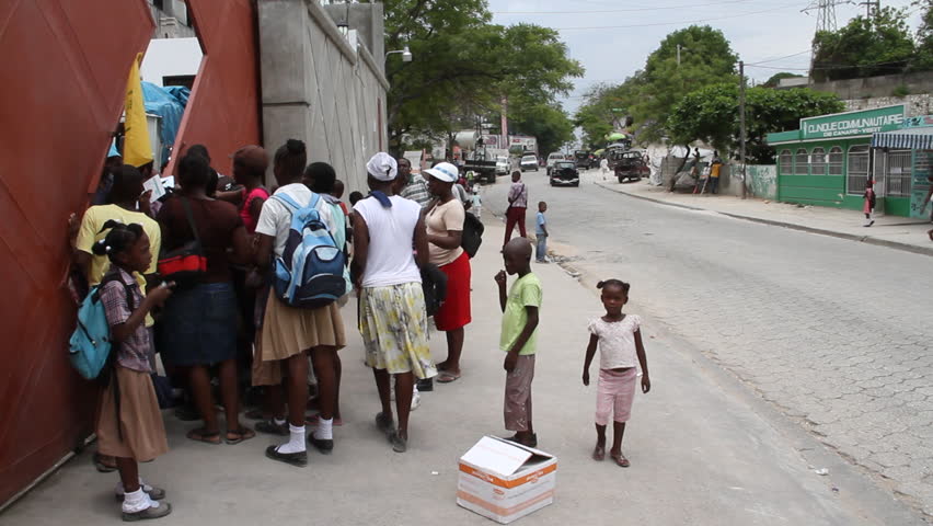 PORT AU PRINCE HAITI  - CIRCA MAY 2012: lines of people on sidewalk at vaccination clinic