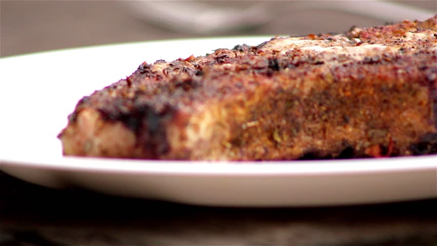 Chef turning thick juicy rib-eye steaks on hot grill,pork steak on a grill