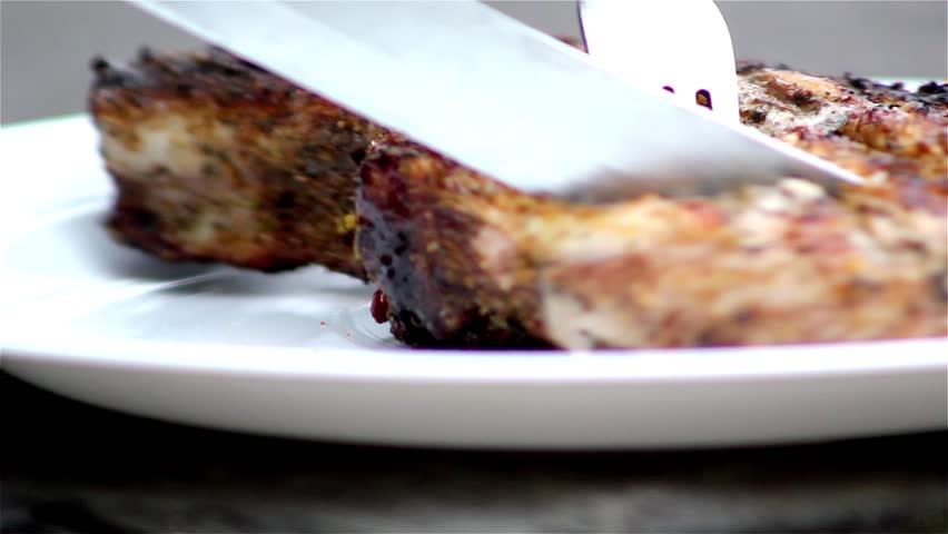 Chef turning thick juicy rib-eye steaks on hot grill,pork steak on a grill