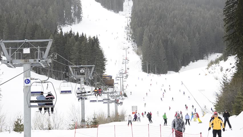 ski resort, chair ski lift elevator lifting people on the mountain ski slope, Bansko, Bulgaria ski centre