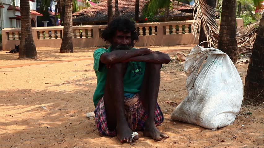CALANGUTE, INDIA - MARCH 11, 2013: Homeless man sitting on the ground and waiting for alms from passers-by. on March 11, 2013 in Calangute, India