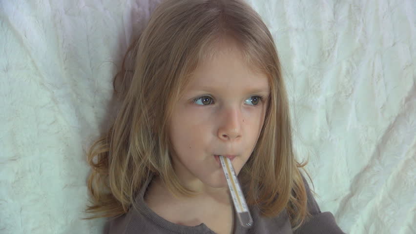 Sick Child Sitting on Sofa with Thermometer, Little Girl Suffering from Cold