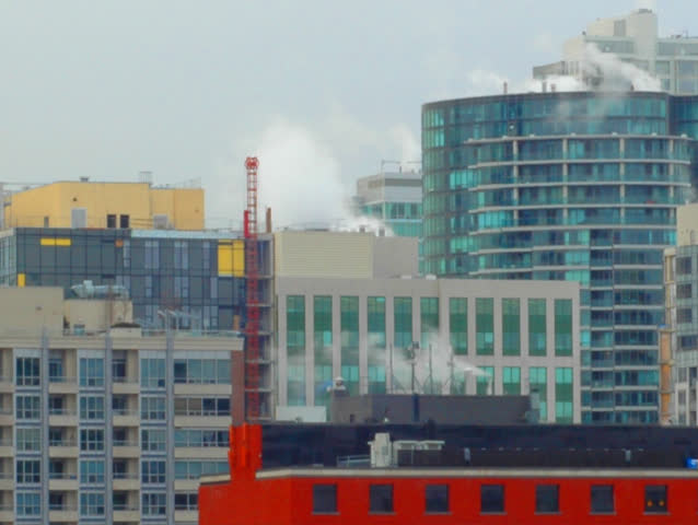 Steam rises in the big city.