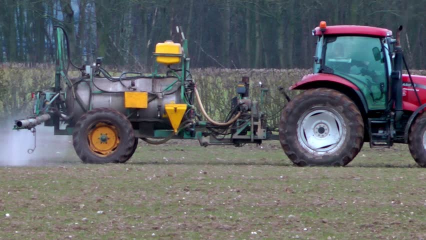 Tractor Spraying Fertilizer Onto A Crop Of Winter Wheat (Staffordshire,UK - March 2013)