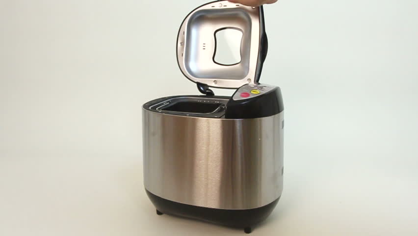Bread maker for baking being opened, pot is taken out and back in
