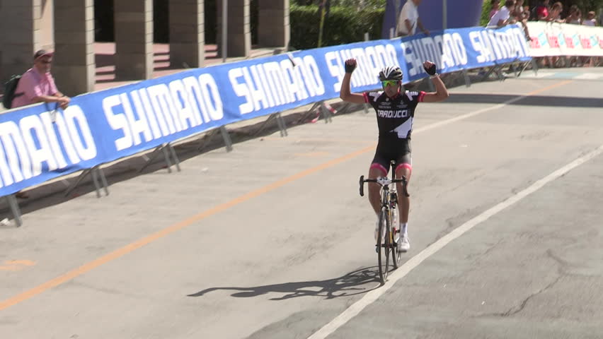 MONEGLIA, ITALY â SEPTEMBER 11: Single cyclist being applauded as he reaches the finish line on September 11 2011 in Moneglia

