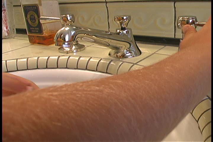 A person washing their hands with soap and water