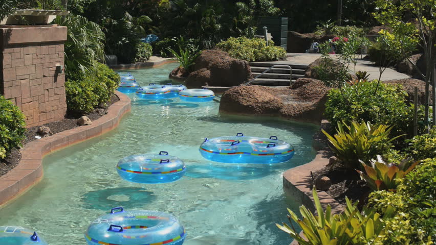 Rafts float down a "lazy river" in a pool.