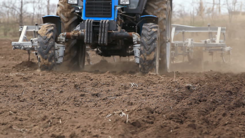 Tractor working on the field,ploughing the farm land