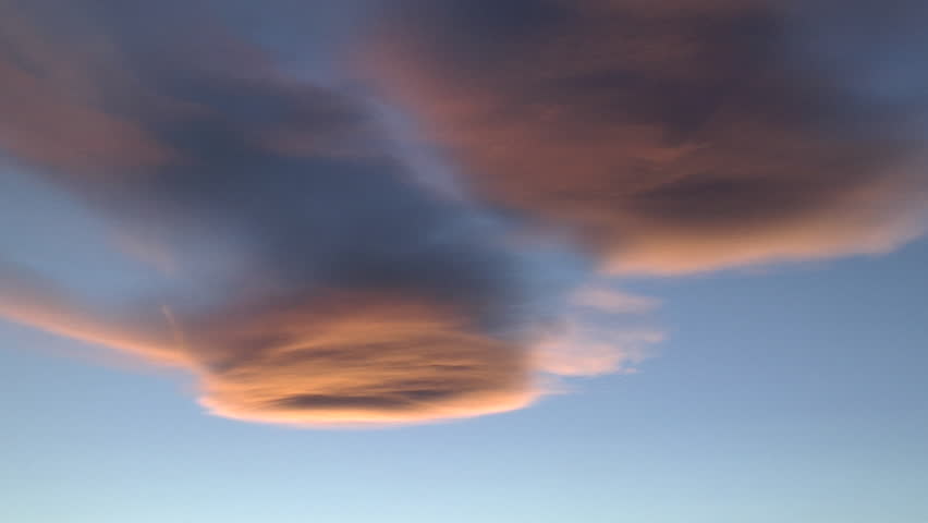 Orange UFOs. Lenticular at sunset colored deep orange