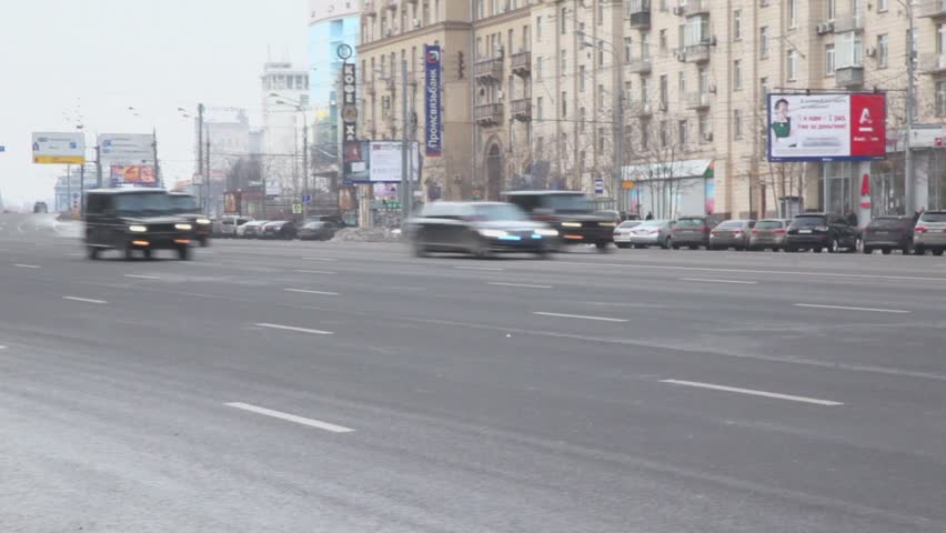 MOSCOW - DEC 20: Governmental autocade with flashers ride by Kutuzovskiy avenue very fast, panoramic motion, Dec 20, 2011, Moscow, Russia. 

