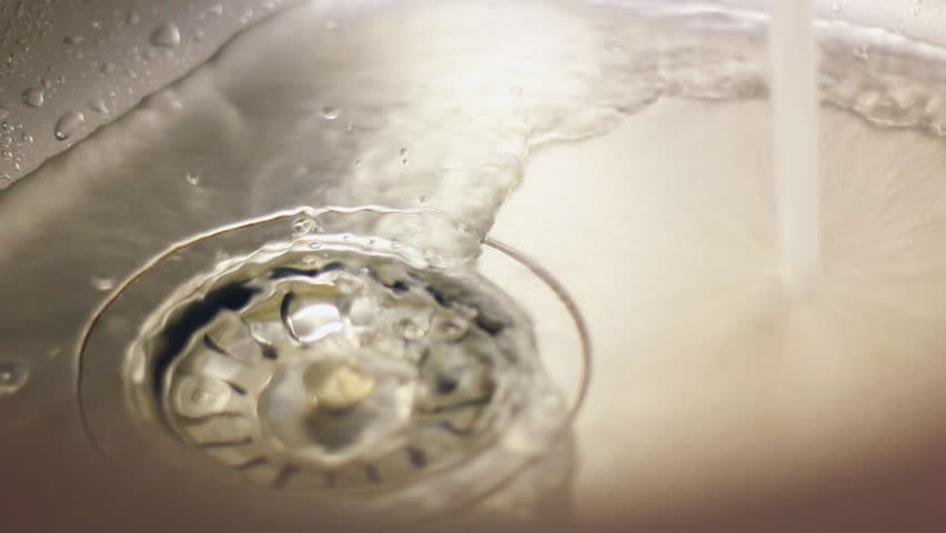 water flows from the tap into the sewer