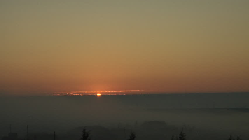 Foggy Sunup. Ground fog is distorted by breaking gravity waves in the morning inversion