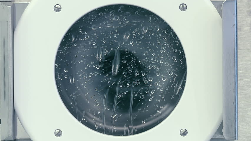 Spin drier removes cleaning fluids from silicon wafers after various chemical treatments as part of silicon chip manufacture in a clean room,. Extreme close up, locked off.