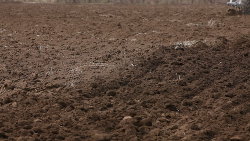 Tractor is plowing farm land.