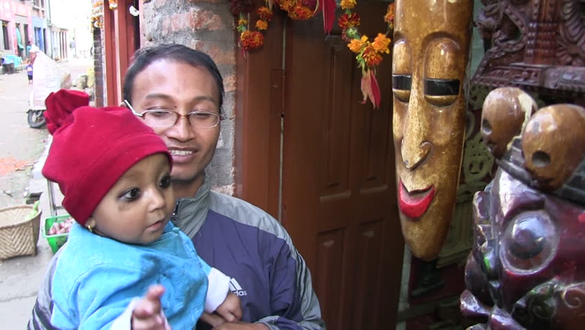 BUNGAMATI REGION, NEPAL â CIRCA OCTOBER 2011 â Nepali baby girl playing with woodcraft with her father circa October 2011 in Bungamati in Nepal.