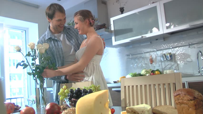 Young expectant parents in home interior
