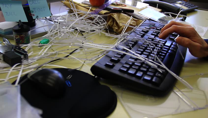 Chaotic office with all sorts of supplies and food. A bad worker, lazy person.