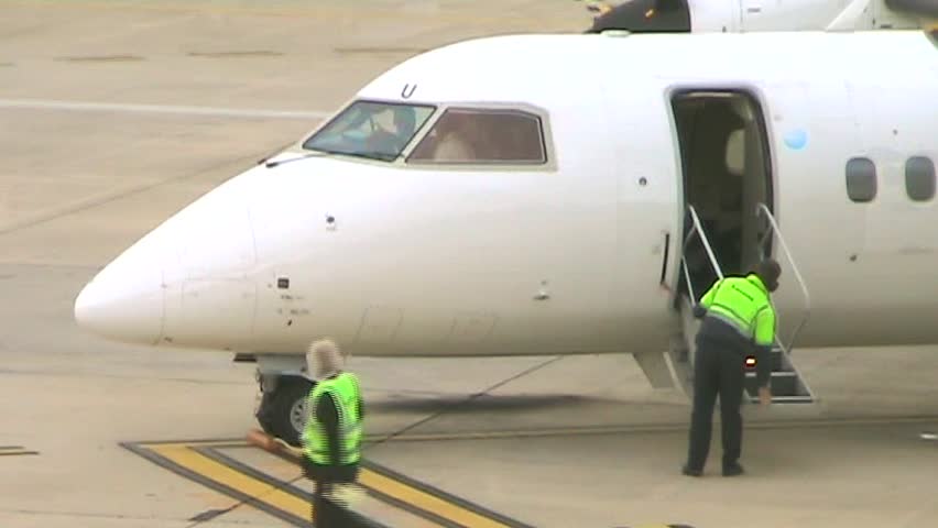 Ground crew prepares a jet for takeoff