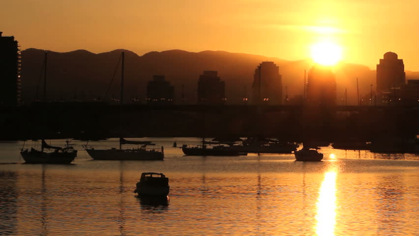 Sunrise Over False Creek, Vancouver. The morning sun rises over the condominiums and anchored boats of Vancouver's False Creek. British Columbia, Canada.
