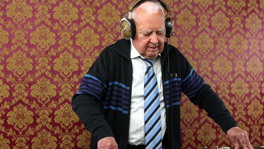 a very funky elderly grandpa dj mixing records
