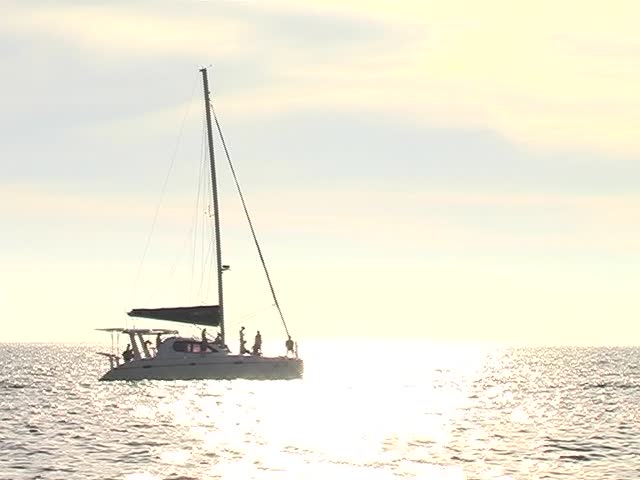 Catamaran sailing away on the ocean