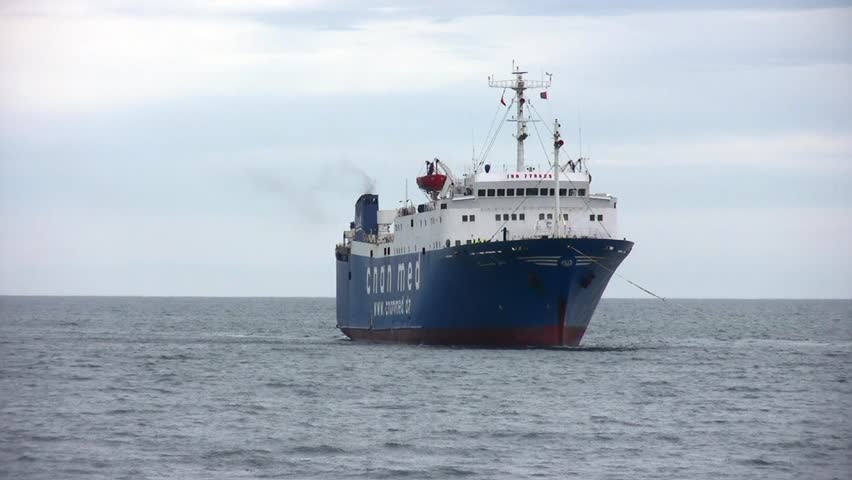 ALICANTE, SPAIN â APRIL 04: The tug "J. TORRES" is working with the general cargo vessel âTELEGHMAâ for entering in the port of Alicante; Spain; on april 04, 2013 in Alicante.