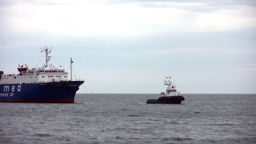 ALICANTE, SPAIN â APRIL 04: The tug "J. TORRES" is working with the general cargo vessel âTELEGHMAâ for entering in the port of Alicante; Spain; on april 04, 2013 in Alicante.