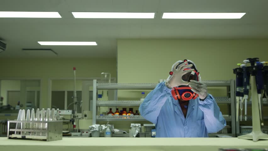 Biotech, dangerous occupation and pharmaceutical lab with researcher wearing protective mask and checking vaccine