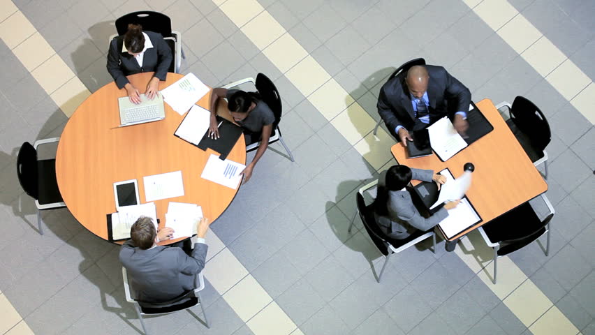 Satisfaction of success by group of multi ethnic business people and clients around table