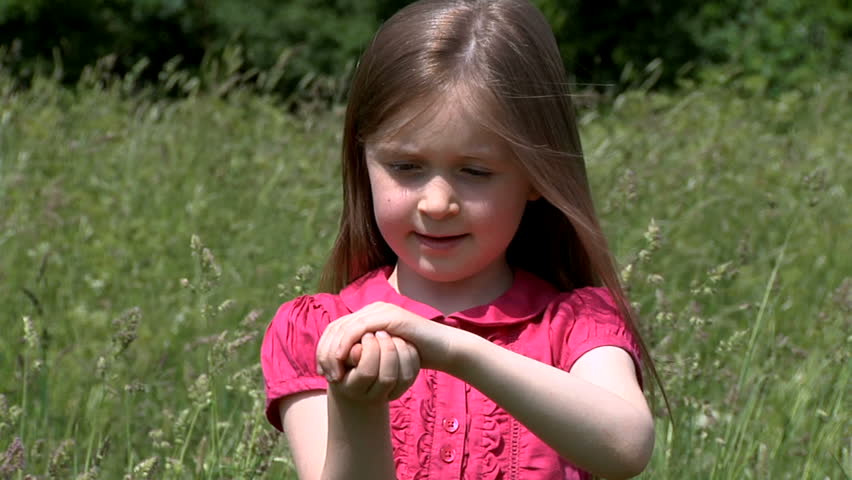 Little girl with butterfly on hand - painted lady