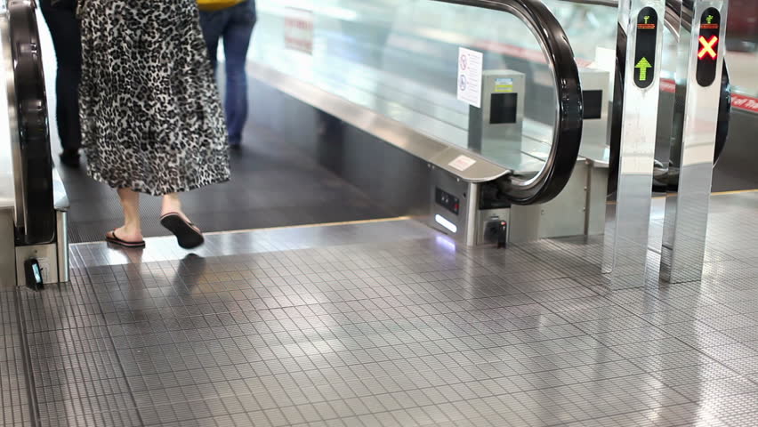 A woman with a cart stands on walkway