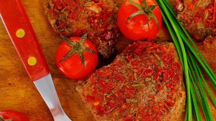 spicy meat on wood with pepper and chives