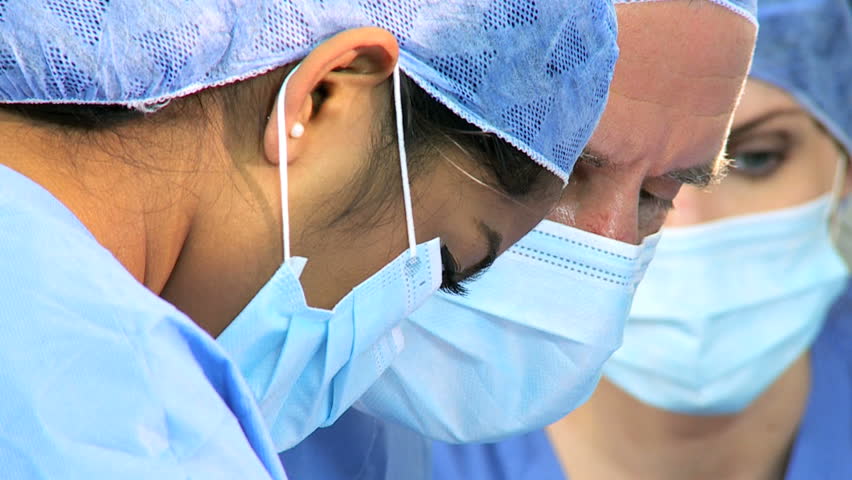 Close up portrait faces multi ethnic surgical team dressed scrubs masks