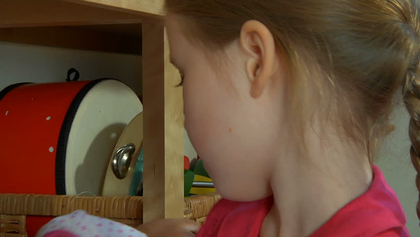 Close up of a little girl cuddling and kissing her doll