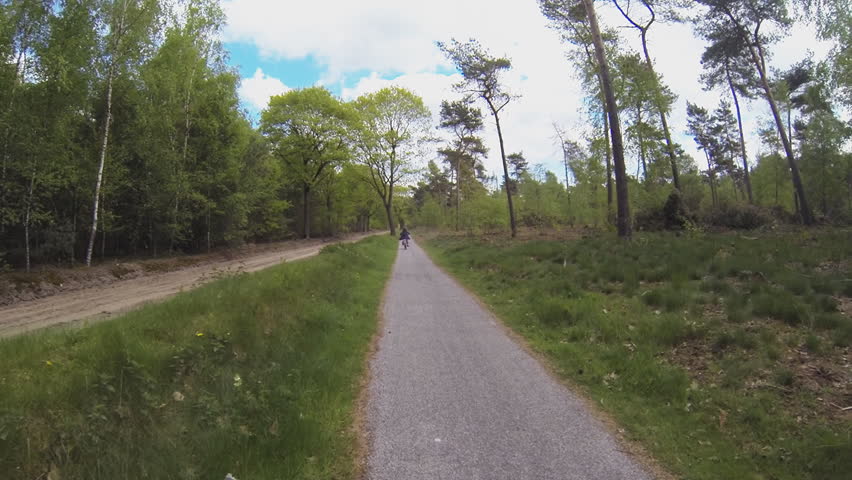 Actioncam footage of cycling in a green landscape (high speed)