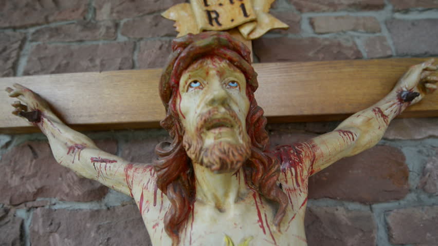 A very bloody and scary jesus on the cross. 10896 
