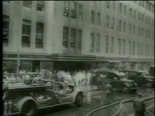 Paramedic team carry away injured people due airplane impact damage at Empire State Building on July, 28, 1945 in New York City-MGM PICTURES, UNIVERSAL-INTERNATIONAL NEWSREEL, USA, filmed in 1964