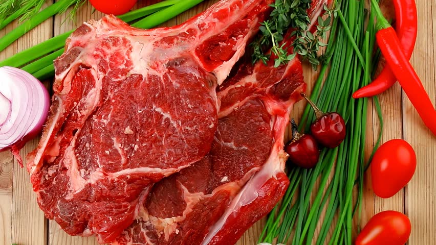 fresh meat : raw beef spare ribs with thyme red chili pepper garlic dill and cherry tomato on wooden board 1920x1080 intro motion slow hidef hd